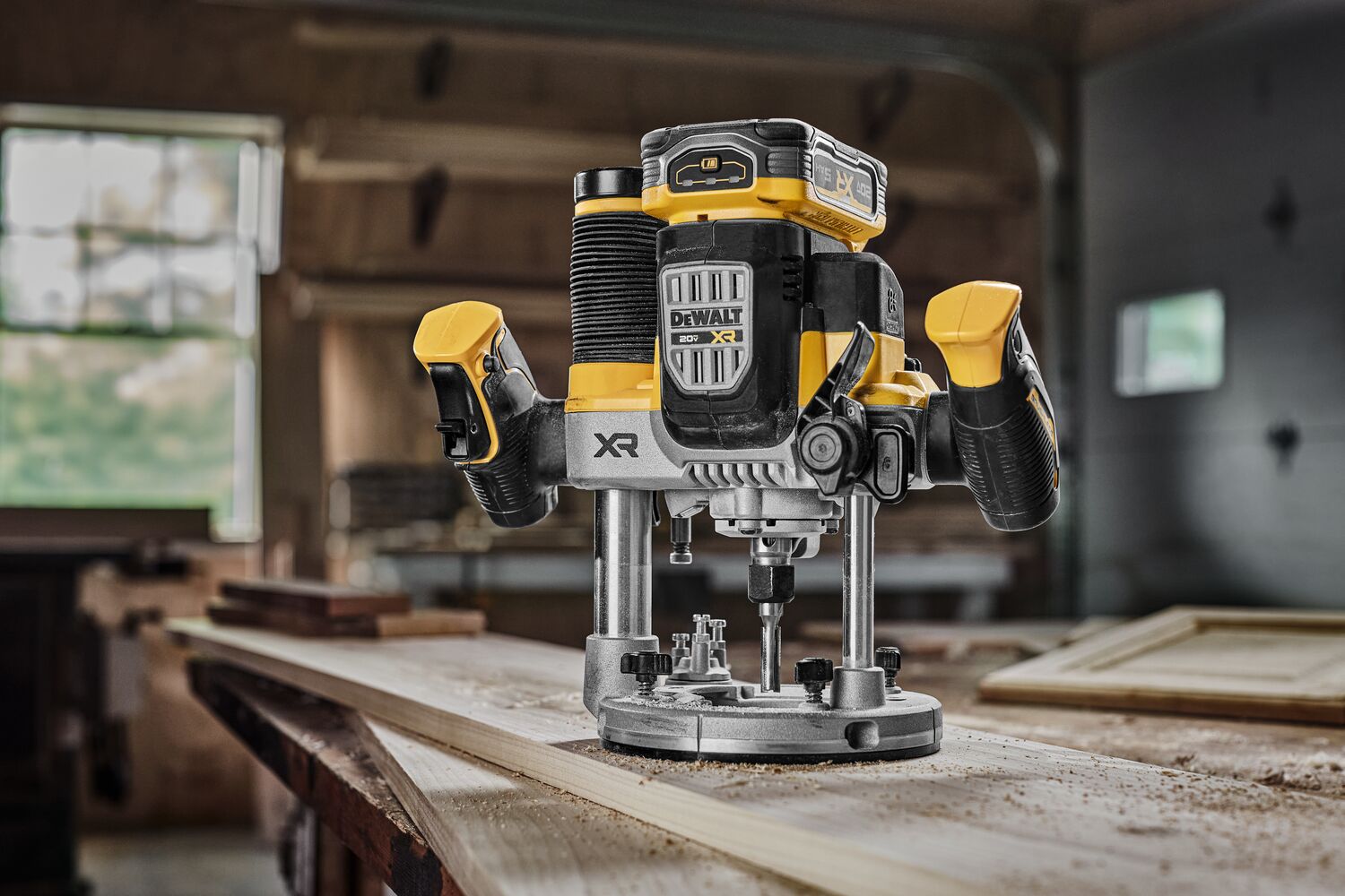 DEWALT XR 20V MAX* Plunge router with 20V MAX* XR 5 ah battery on wood surface not in use