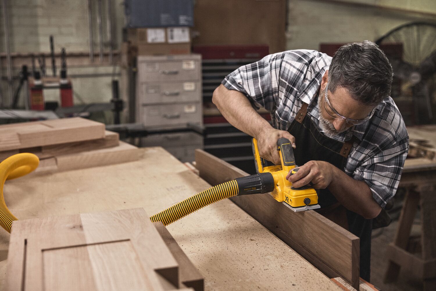 Talent sanding wooden material in a residential environment
