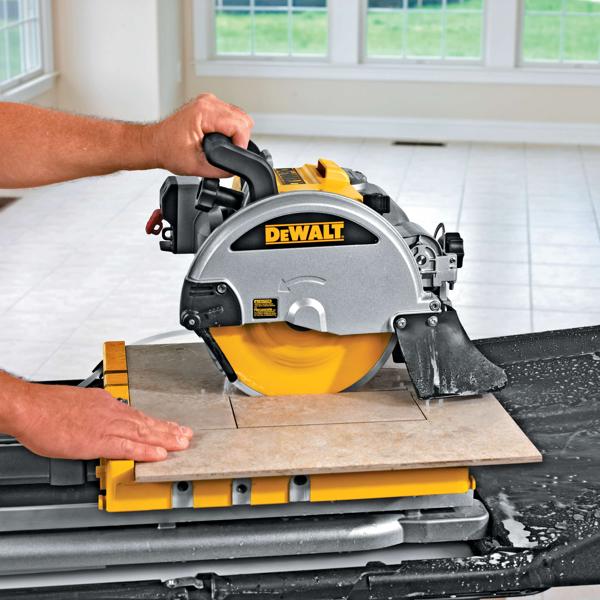 wet tile saw being used by person to cut rectangular tile